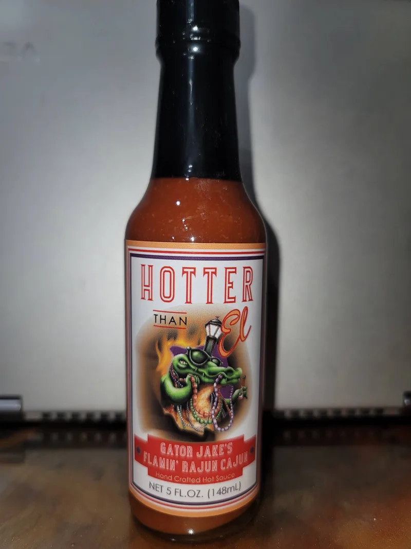 Hotter than El Gator Jake's Flamin' Rajun Cajun Hot Sauce hot sauce bottle